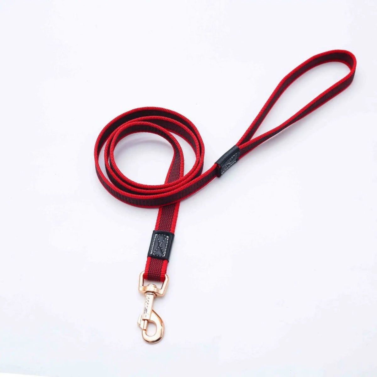 Red non-slip dog leash coiled with black handle accent and rose gold clip