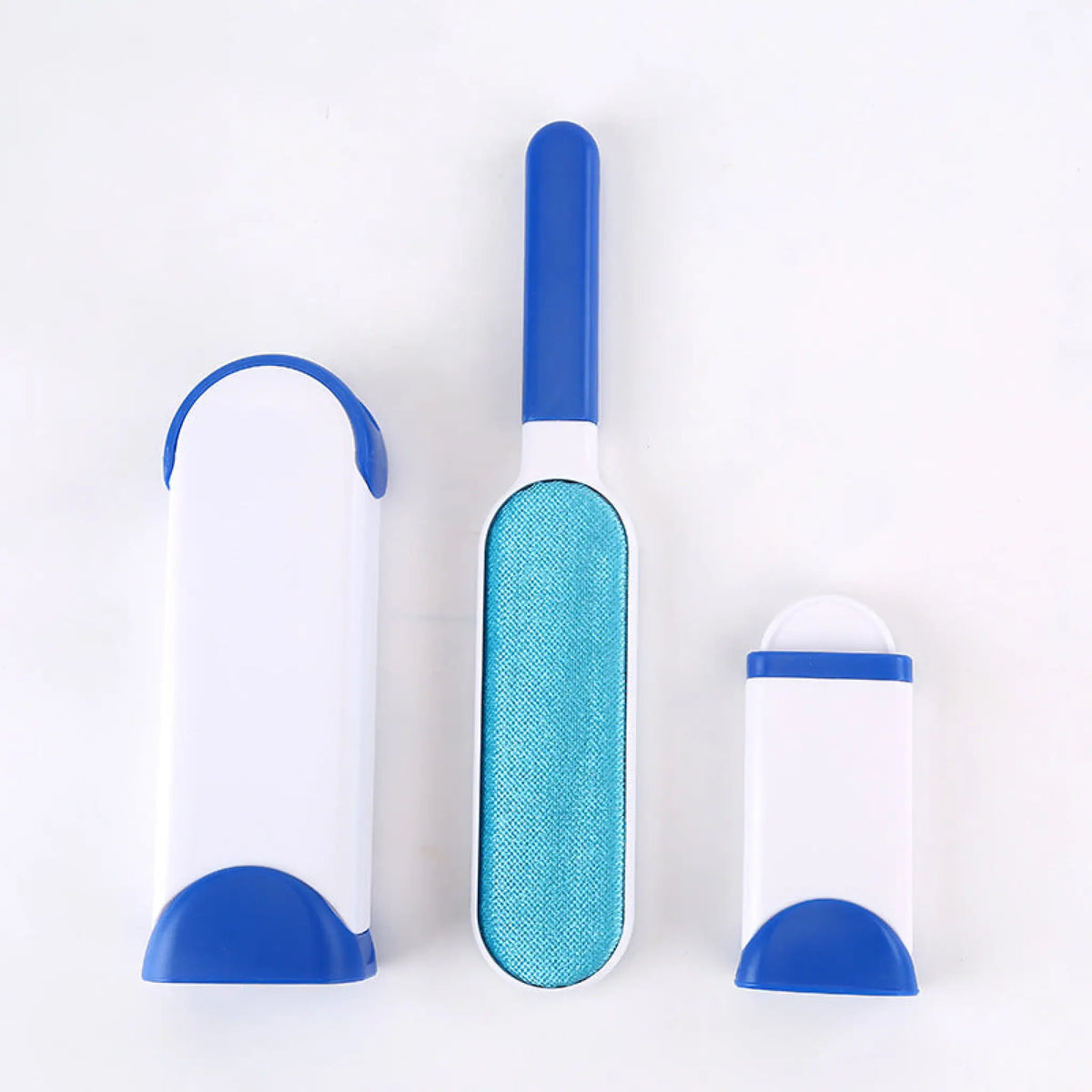 Blue pet hair remover brush with fabric pad beside its self-cleaning base and mini base