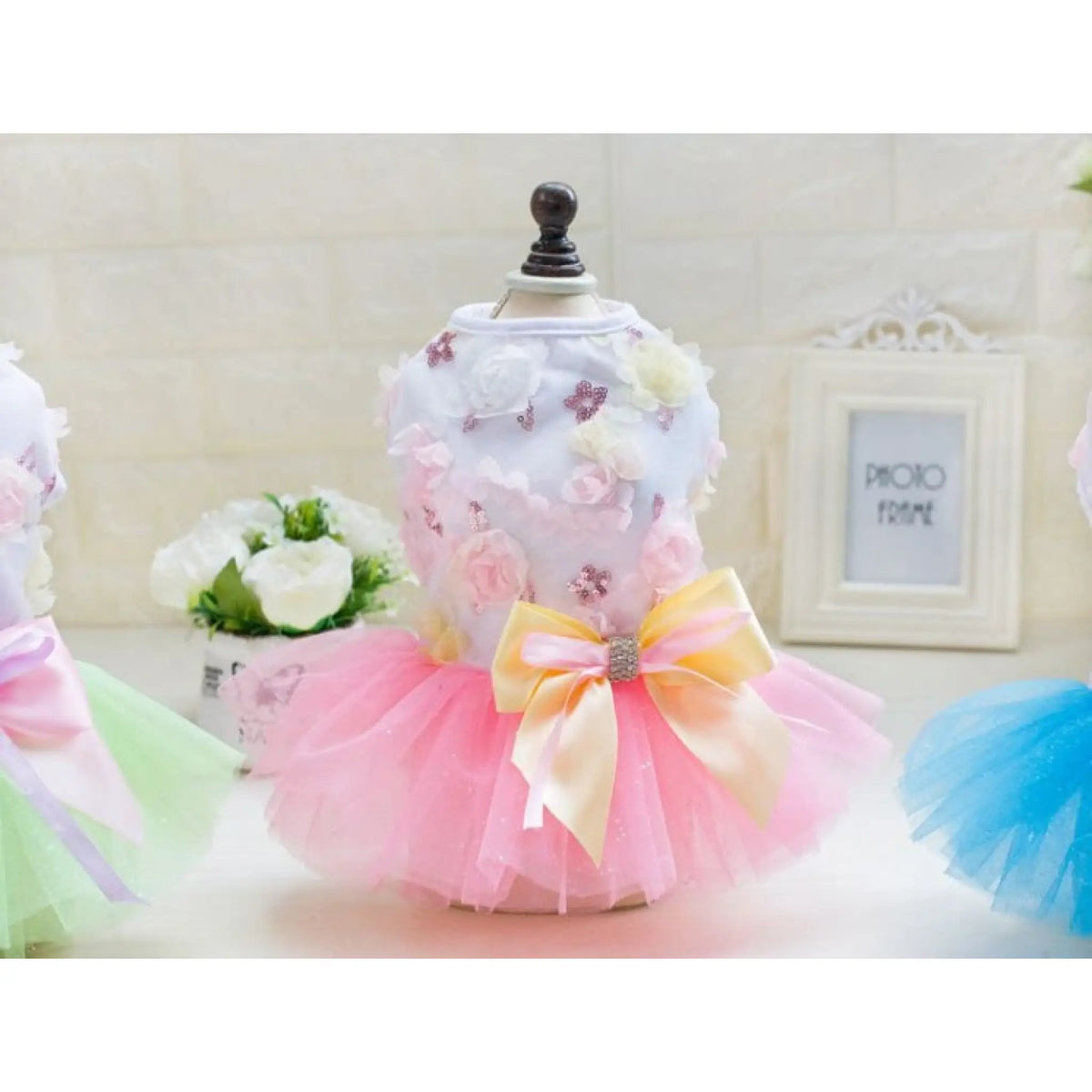 Pink tutu dog dress with floral lace bodice displayed on mannequin