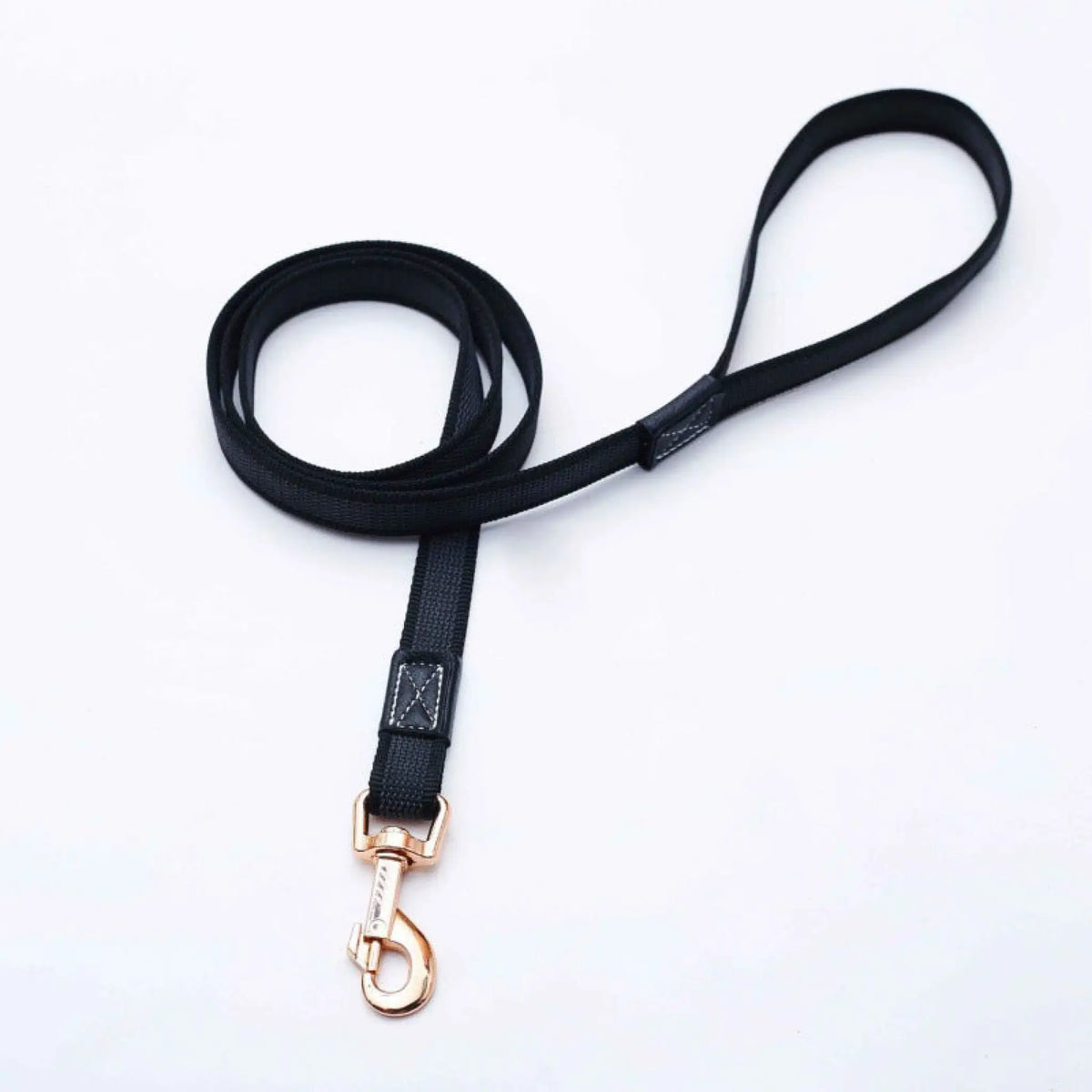 Black non-slip dog leash coiled with padded handle and rose gold snap clip