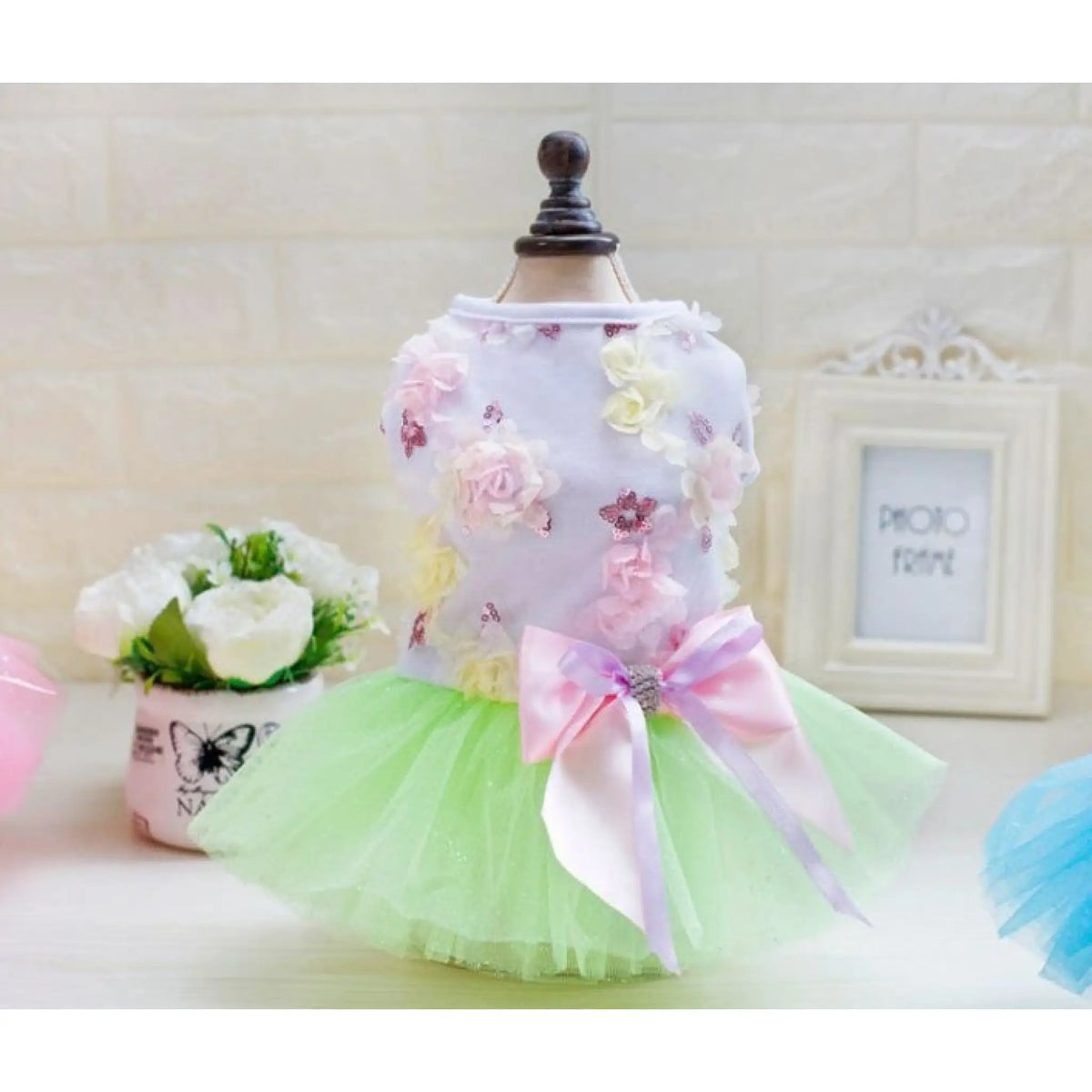 Mint green floral tutu dog dress with lavender satin bow on mannequin
