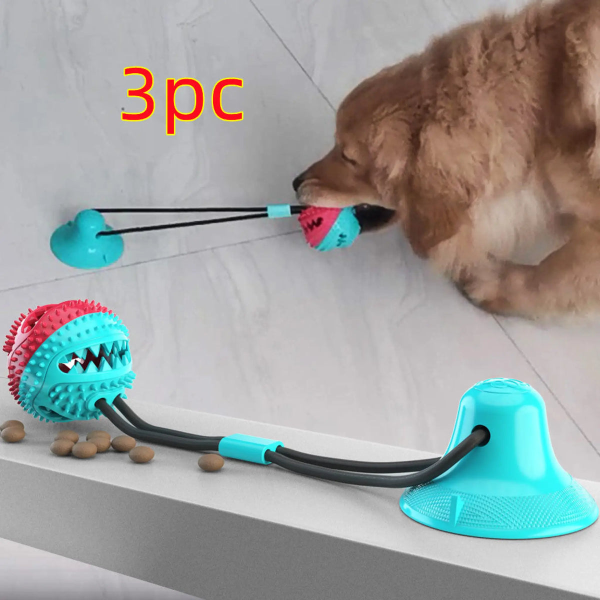 Red and white suction cup dog tug toy with spiky treat ball and rope tether
