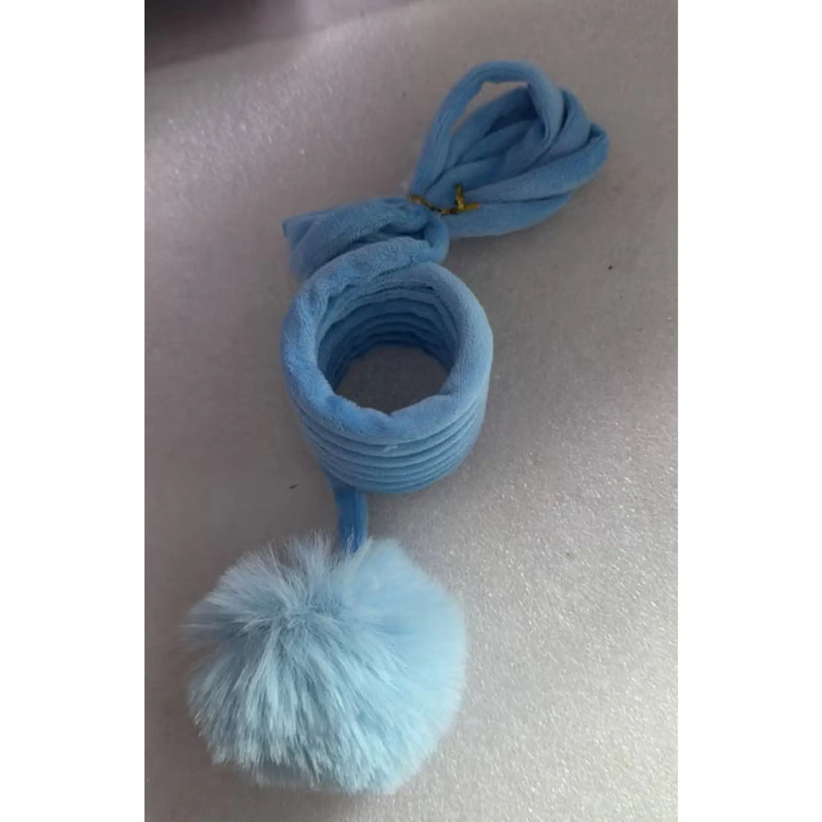 Blue plush coil cat toy with loop hanger and fluffy pom-pom ball